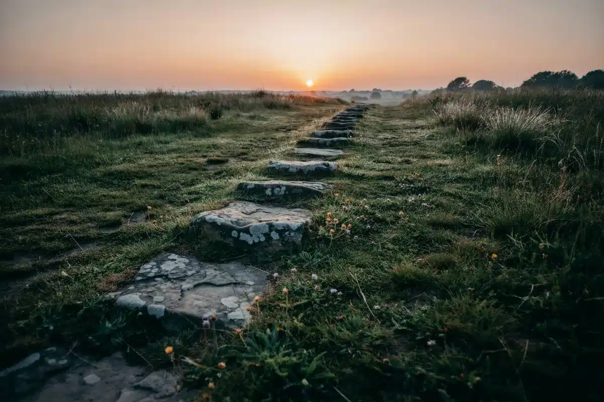 1234 Angel Number and Personal Growth Stone steps leading toward a golden sunrise over a misty landscape