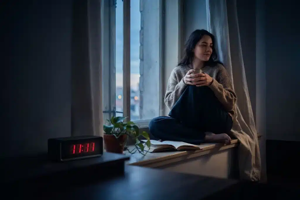 Person reflecting beside a digital clock displaying 11:11