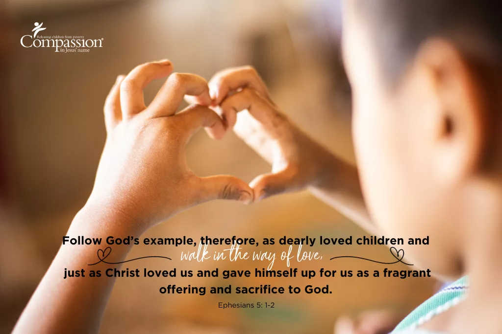 Hands forming heart around a child, representing acts of love in a spiritual life with God.